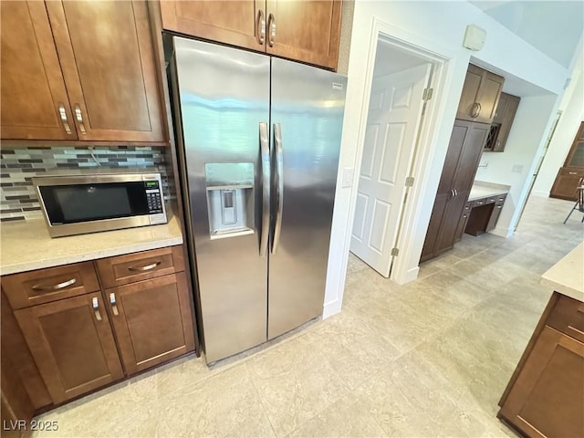 2406 Showcase Dr, Las Vegas, NV 89134 - kitchen featuring stainless steel appliances, light countertops, and tasteful backsplash