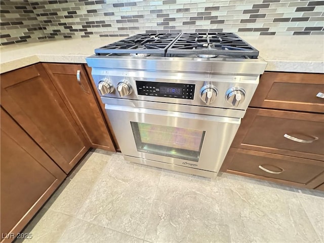 2406 Showcase Dr, Las Vegas, NV 89134 - kitchen view of stainless steel gas range oven, tasteful backsplash, light countertops, and brown cabinetry