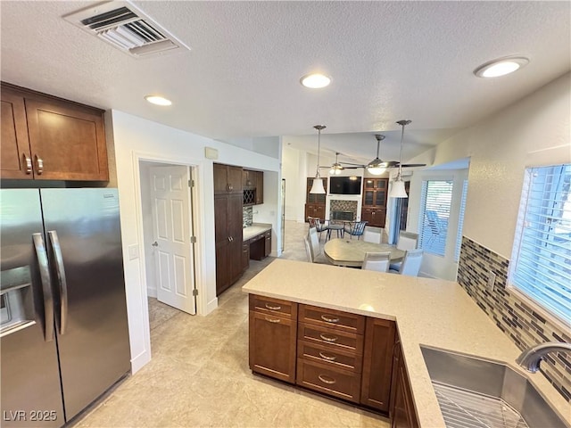 2406 Showcase Dr, Las Vegas, NV 89134 - kitchen featuring stainless steel fridge with ice dispenser, ceiling fan, a textured ceiling, light countertops, and recessed lighting