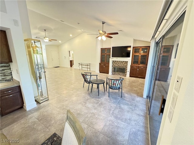 2406 Showcase Dr, Las Vegas, NV 89134 - living area featuring ceiling fan, lofted ceiling, and a fireplace