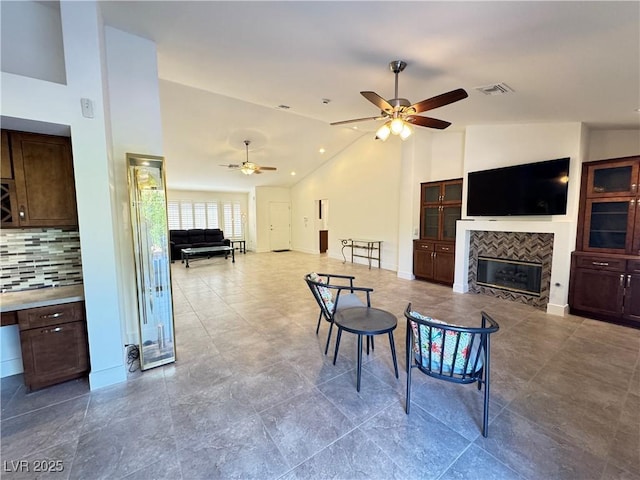 2406 Showcase Dr, Las Vegas, NV 89134 - living area featuring a ceiling fan, a tile fireplace, and high vaulted ceiling