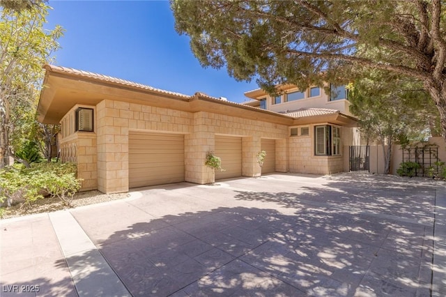 9801 Orient Express Ct, Las Vegas, NV 89145 - view of front of property featuring a garage, a tile roof, and concrete driveway