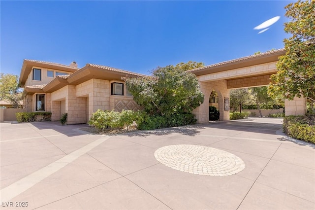 9801 Orient Express Ct, Las Vegas, NV 89145 - view of front of house featuring a chimney and curved driveway
