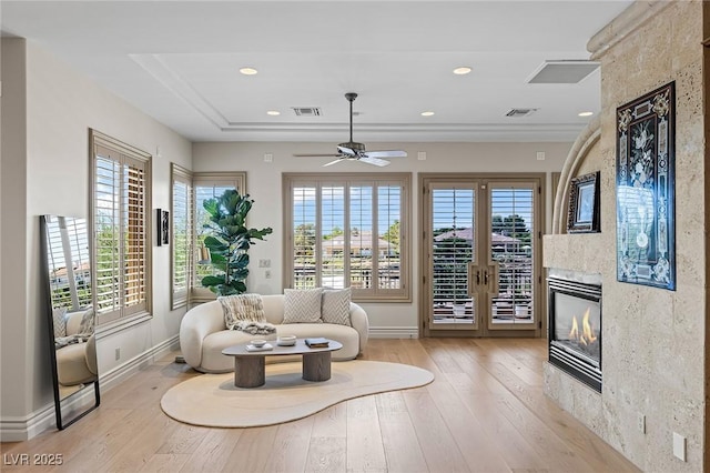 9801 Orient Express Ct, Las Vegas, NV 89145 - living room featuring a premium fireplace, plenty of natural light, light wood-style floors, french doors, and recessed lighting