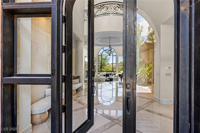 9801 Orient Express Ct, Las Vegas, NV 89145 - doorway to outside with arched walkways, inlaid floor details, french doors, and marble tiled flooring