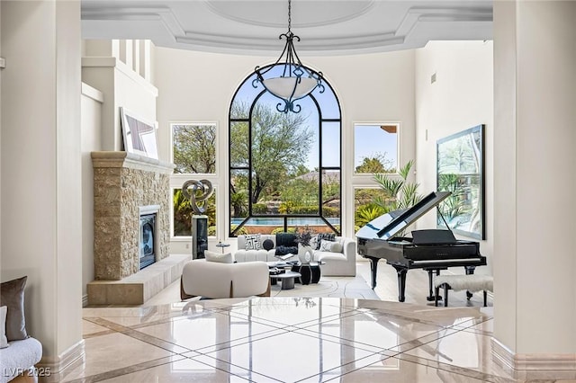 9801 Orient Express Ct, Las Vegas, NV 89145 - sitting room with inlaid floor details, a glass covered fireplace, a towering ceiling, and marble tiled floors