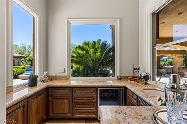 9801 Orient Express Ct, Las Vegas, NV 89145 - kitchen with light stone countertops and wine cooler