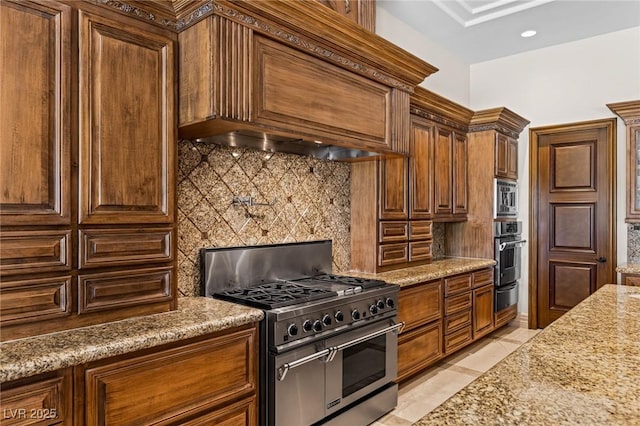 9801 Orient Express Ct, Las Vegas, NV 89145 - kitchen with appliances with stainless steel finishes, backsplash, premium range hood, light stone counters, and light tile patterned floors