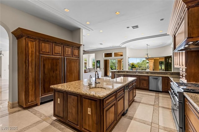 9801 Orient Express Ct, Las Vegas, NV 89145 - kitchen featuring inlaid floor details, high end appliances, arched walkways, recessed lighting, and light stone countertops