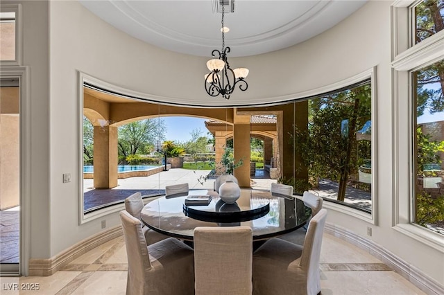 9801 Orient Express Ct, Las Vegas, NV 89145 - dining area with inlaid floor details, plenty of natural light, and a chandelier