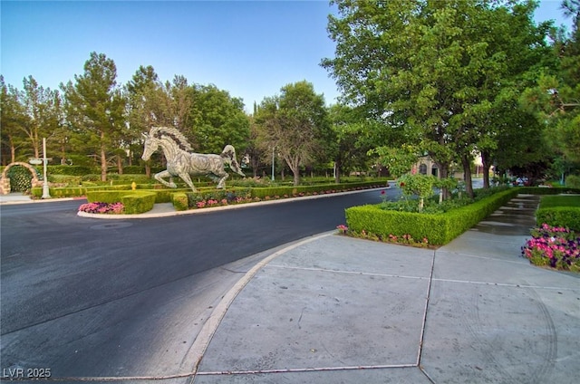 9801 Orient Express Ct, Las Vegas, NV 89145 - view of asphalt street with sidewalks, curbs, and view of wooded area
