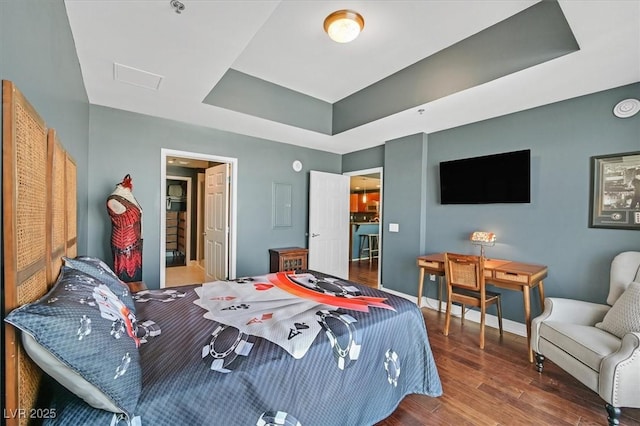 150 Las Vegas Blvd Unit 1004, Las Vegas, NV 89101 - bedroom featuring wood finished floors, a tray ceiling, and attic access