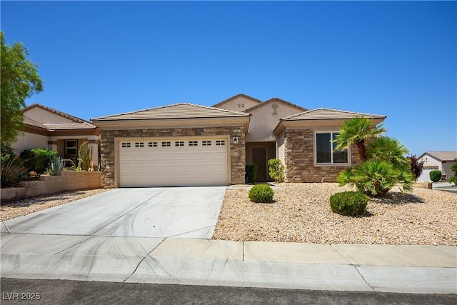 2563 Sargon St, Henderson, NV 89044 - view of front of house with an attached garage, stone siding, concrete driveway, and a tiled roof
