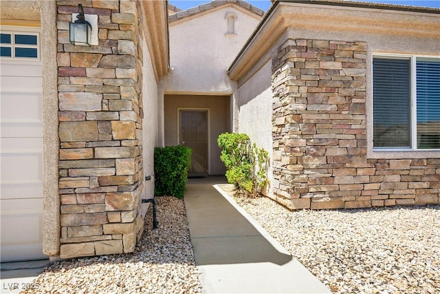2563 Sargon St, Henderson, NV 89044 - doorway to property featuring stone siding and stucco siding