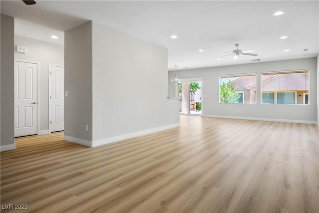2563 Sargon St, Henderson, NV 89044 - unfurnished living room featuring ceiling fan, recessed lighting, light wood-style flooring, and a chandelier