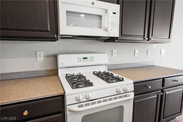 2563 Sargon St, Henderson, NV 89044 - kitchen featuring white appliances and dark brown cabinets