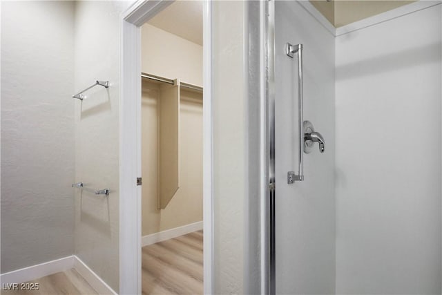 2563 Sargon St, Henderson, NV 89044 - bathroom featuring wood finished floors and a stall shower