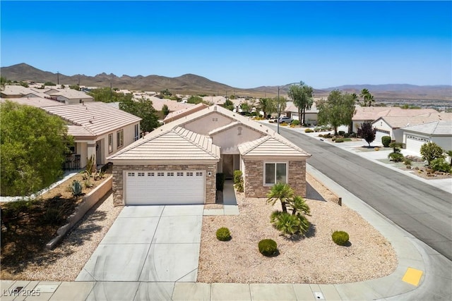 2563 Sargon St, Henderson, NV 89044 - single story home with a garage, a mountain view, concrete driveway, and stone siding