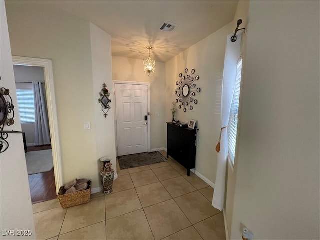 5625 Fast Payout Ct, Las Vegas, NV 89122 - foyer entrance with a chandelier and light tile patterned flooring