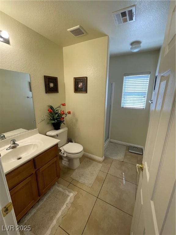 5625 Fast Payout Ct, Las Vegas, NV 89122 - bathroom featuring a textured ceiling, vanity, tile patterned flooring, a stall shower, and a textured wall