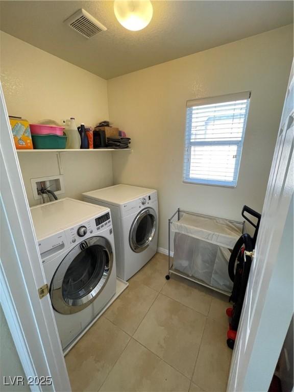 5625 Fast Payout Ct, Las Vegas, NV 89122 - washroom featuring washing machine and dryer and light tile patterned flooring