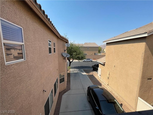 5625 Fast Payout Ct, Las Vegas, NV 89122 - view of side of home featuring stucco siding and a tile roof