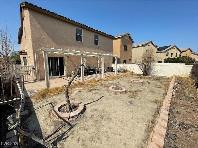 5625 Fast Payout Ct, Las Vegas, NV 89122 - rear view of house featuring an outdoor fire pit, stucco siding, a fenced backyard, and a pergola