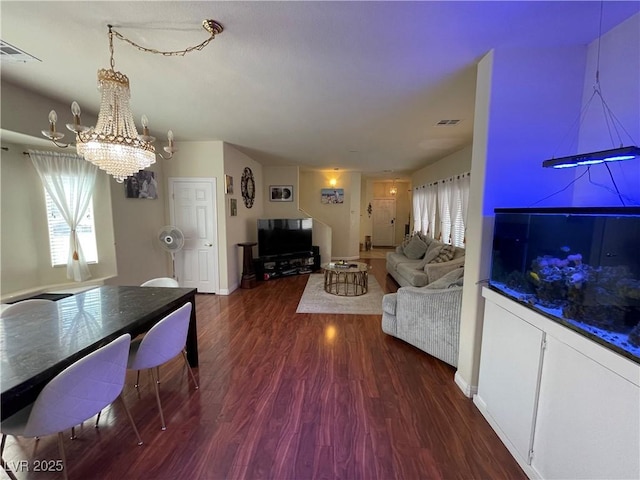 5625 Fast Payout Ct, Las Vegas, NV 89122 - living area featuring a chandelier, wood finished floors, and plenty of natural light