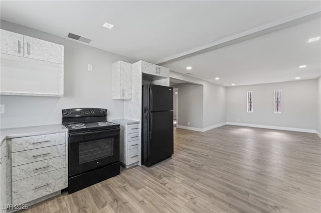 2222 N Martin L King Blvd, Las Vegas, NV 89106 - kitchen with black appliances, light countertops, light wood-style floors, white cabinetry, and recessed lighting