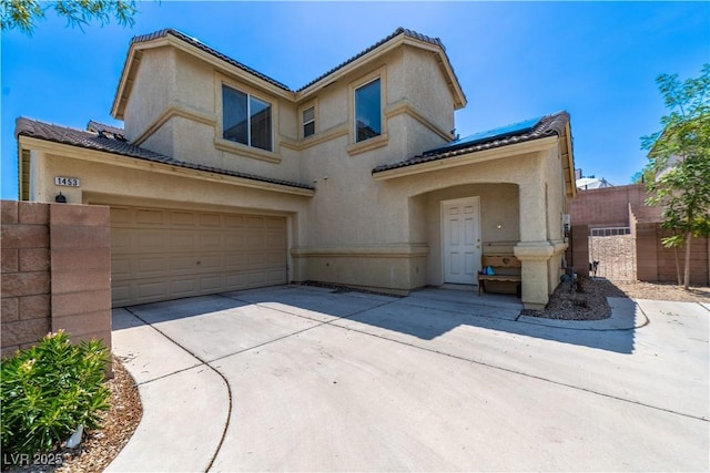 1453 Evening Song Ave, Henderson, NV 89012 - mediterranean / spanish-style home with concrete driveway, a tiled roof, and stucco siding