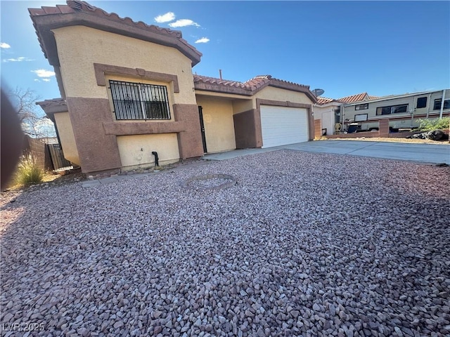 2503 River Oaks Dr, Las Vegas, NV 89156 - mediterranean / spanish house featuring an attached garage, stucco siding, driveway, and a tiled roof