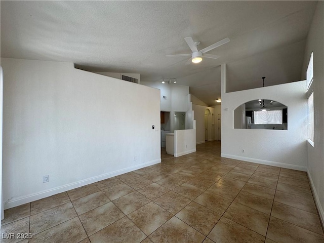 2503 River Oaks Dr, Las Vegas, NV 89156 - unfurnished living room with lofted ceiling, ceiling fan, tile patterned floors, and arched walkways