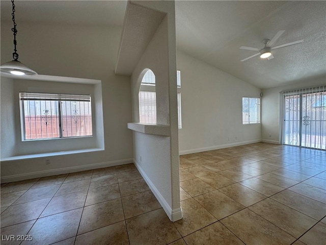 2503 River Oaks Dr, Las Vegas, NV 89156 - tiled empty room featuring vaulted ceiling, a ceiling fan, and a textured ceiling