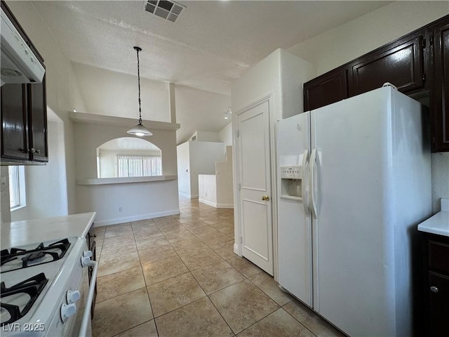 2503 River Oaks Dr, Las Vegas, NV 89156 - kitchen featuring white appliances, light tile patterned floors, ventilation hood, hanging light fixtures, and light countertops