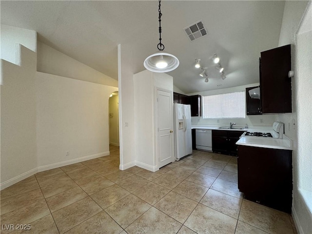 2503 River Oaks Dr, Las Vegas, NV 89156 - kitchen with lofted ceiling, light tile patterned floors, light countertops, white appliances, and arched walkways
