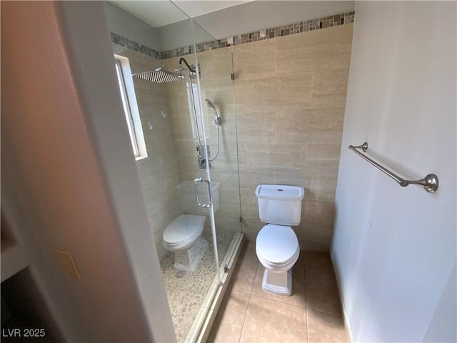 5753 E Monroe Ave, Las Vegas, NV 89110 - bathroom featuring a shower stall, tile patterned floors, and tile walls