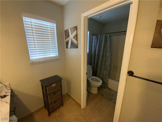 5753 E Monroe Ave, Las Vegas, NV 89110 - bathroom with shower / tub combo with curtain and tile patterned floors