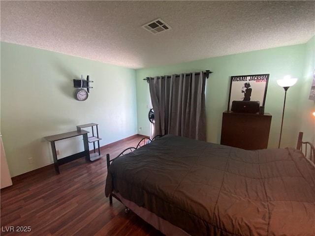 5753 E Monroe Ave, Las Vegas, NV 89110 - bedroom with wood finished floors and a textured ceiling