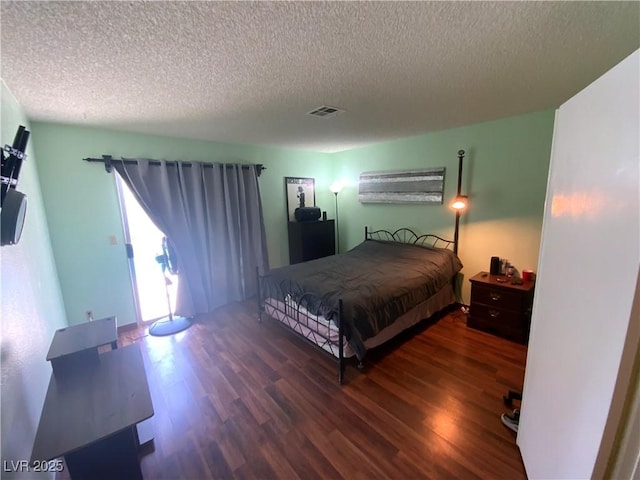5753 E Monroe Ave, Las Vegas, NV 89110 - bedroom featuring wood finished floors and a textured ceiling