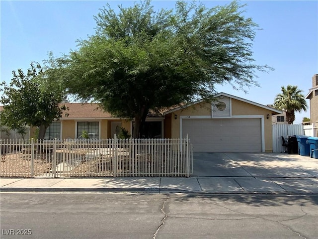 5753 E Monroe Ave, Las Vegas, NV 89110 - view of front of home featuring a garage, driveway, and stucco siding