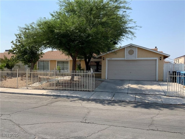 5753 E Monroe Ave, Las Vegas, NV 89110 - view of front of property featuring stucco siding, an attached garage, and driveway