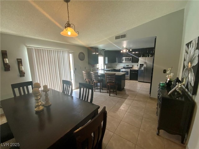 5753 E Monroe Ave, Las Vegas, NV 89110 - dining space featuring light tile patterned floors and a textured ceiling