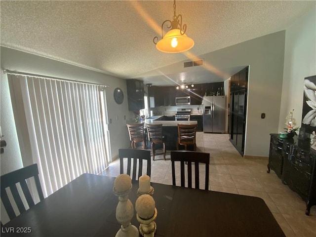 5753 E Monroe Ave, Las Vegas, NV 89110 - dining area featuring a textured ceiling and light tile patterned floors
