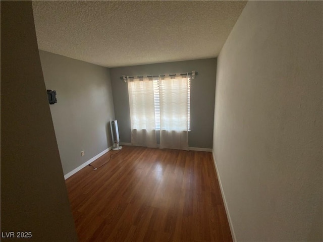 5753 E Monroe Ave, Las Vegas, NV 89110 - spare room with wood finished floors, a textured ceiling, and radiator