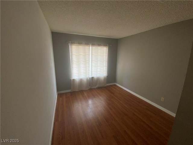 5753 E Monroe Ave, Las Vegas, NV 89110 - unfurnished room featuring wood finished floors and a textured ceiling