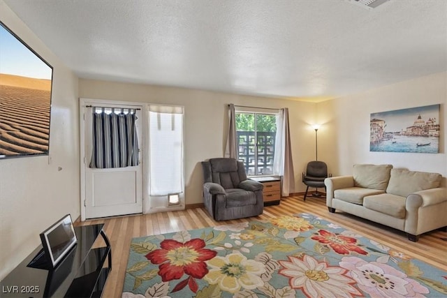 1481 Lorilyn Ave Unit 1, Las Vegas, NV 89119 - living area with wood finished floors and a textured ceiling