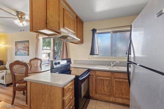 1481 Lorilyn Ave Unit 1, Las Vegas, NV 89119 - kitchen with freestanding refrigerator, electric range, light countertops, a peninsula, and ceiling fan