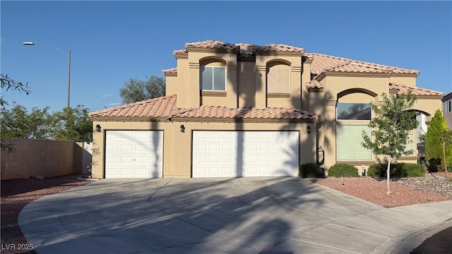 4708 English Ivy Ct, Las Vegas, NV 89130 - mediterranean / spanish house featuring stucco siding, concrete driveway, a tiled roof, and an attached garage