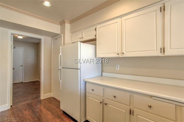 kitchen featuring white fridge, crown molding, dark hardwood / wood-style floors, and white cabinets