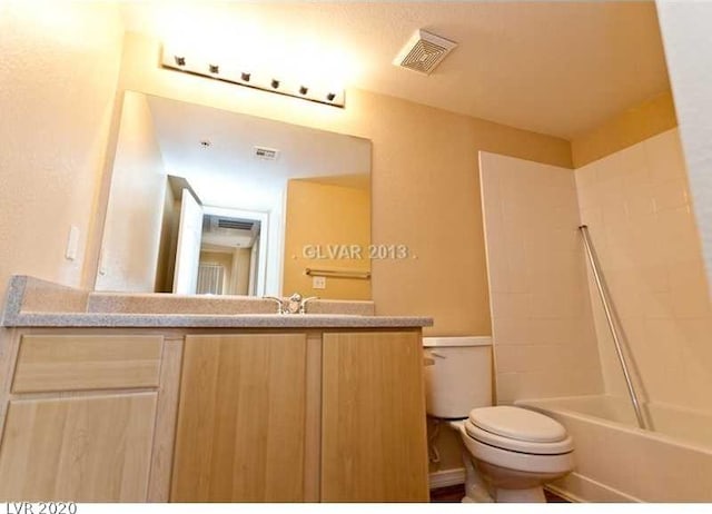 full bathroom featuring toilet, vanity, and shower / tub combination